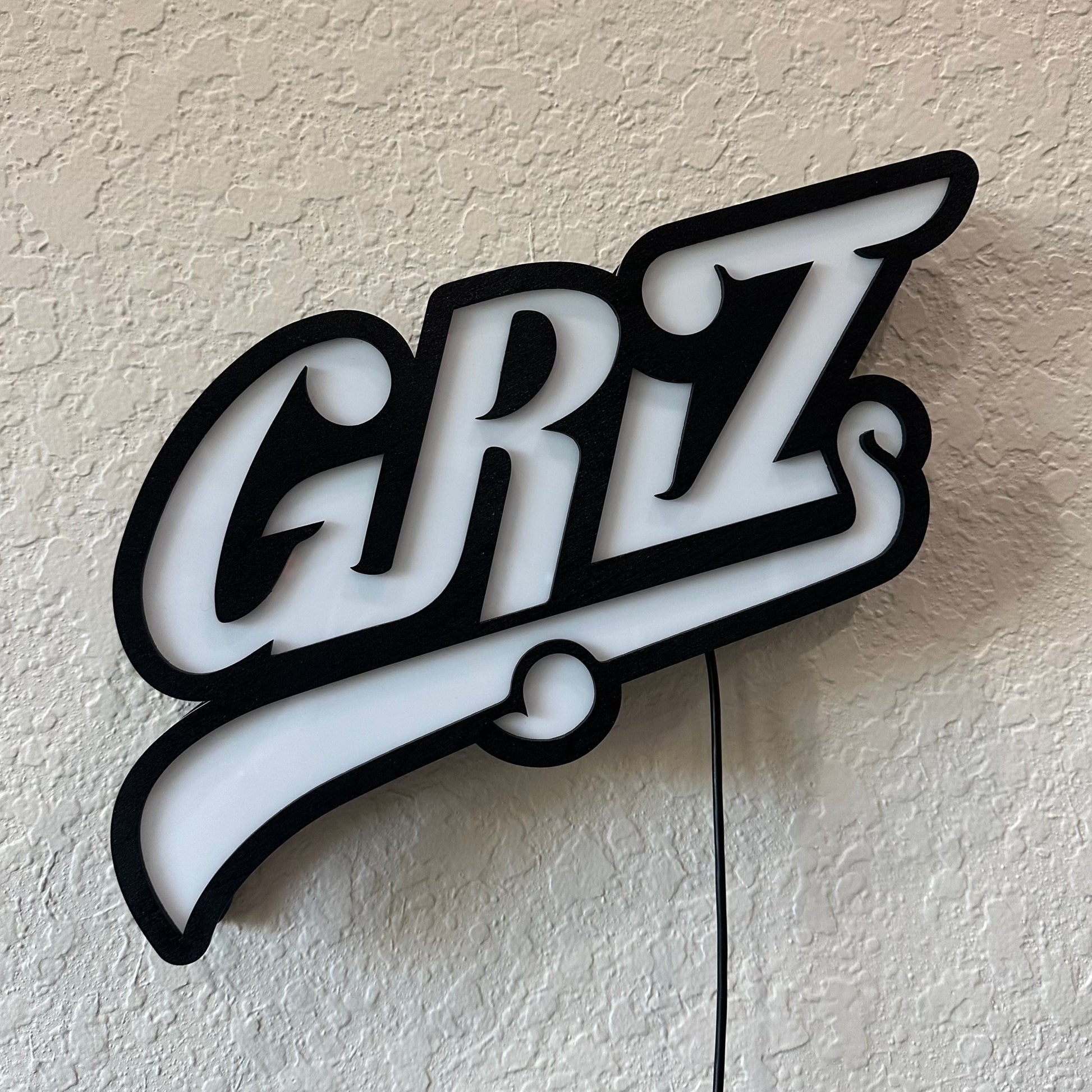 GRiZ LED sign turned off, showing the opaque plexiglass and black wood trim.